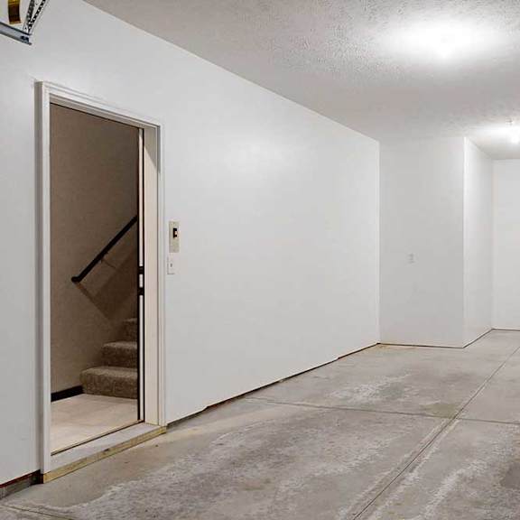 Thumbnail 5 of 24 A two-car tandem garage directly attached to an apartment.
