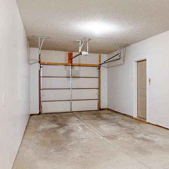 Thumbnail 4 of 24 A two-car tandem garage directly attached to an apartment.