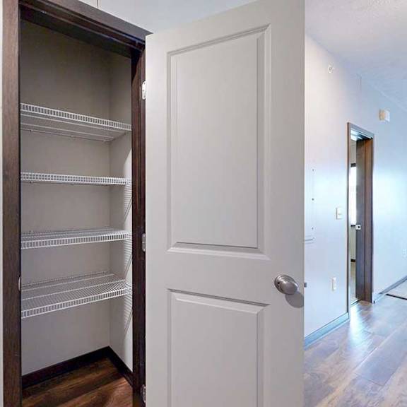 Thumbnail 12 of 24 A storage closet with built-in wire shelves.