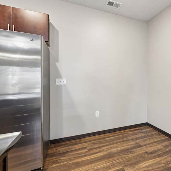 Thumbnail 9 of 14 Bright flex space or bedroom with neutral walls, wood-style flooring, and an open layout ready for customization.