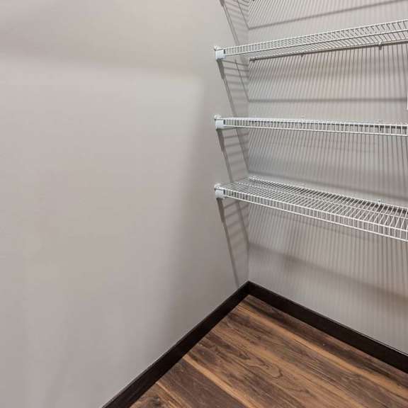 Thumbnail 7 of 14 Walk-in pantry or storage closet with white wire shelving and generous vertical storage space.