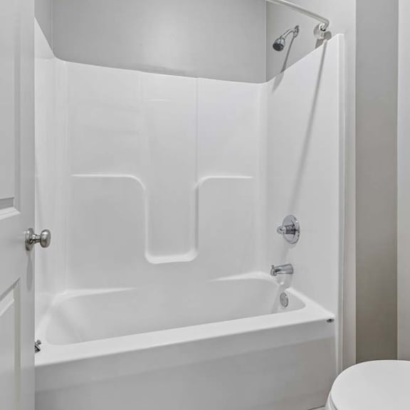 Thumbnail 18 of 18 Bathroom with white tub-shower combination, built-in surround, and neutral walls for a clean, bright look.