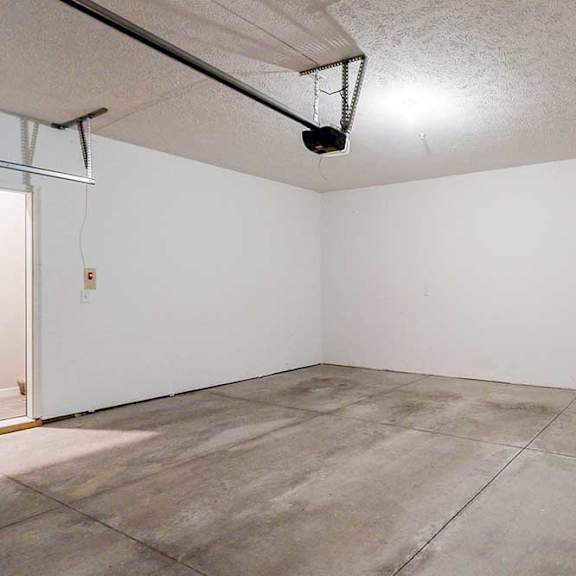 Thumbnail 20 of 26 A two-car double garage with a door leading directly to the apartment.