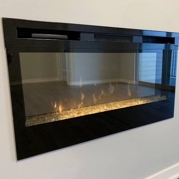 Thumbnail 7 of 21 A black fireplace with a fire burning inside.