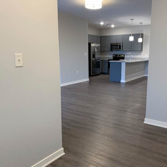 Thumbnail 10 of 21 A kitchen area with a countertop and cabinets.