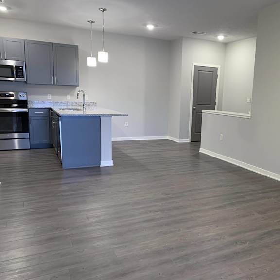 spacious living and dining room with fireplace for extra warmth at the villas at mahoney park