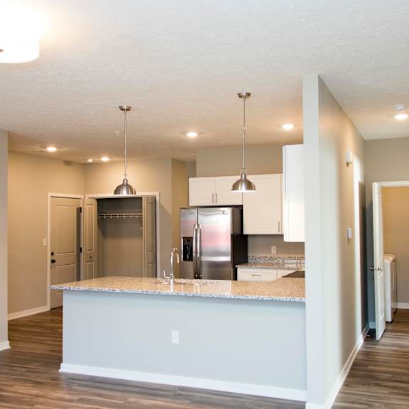 Thumbnail 3 of 17 A kitchen with a granite countertop and stainless steel appliances.