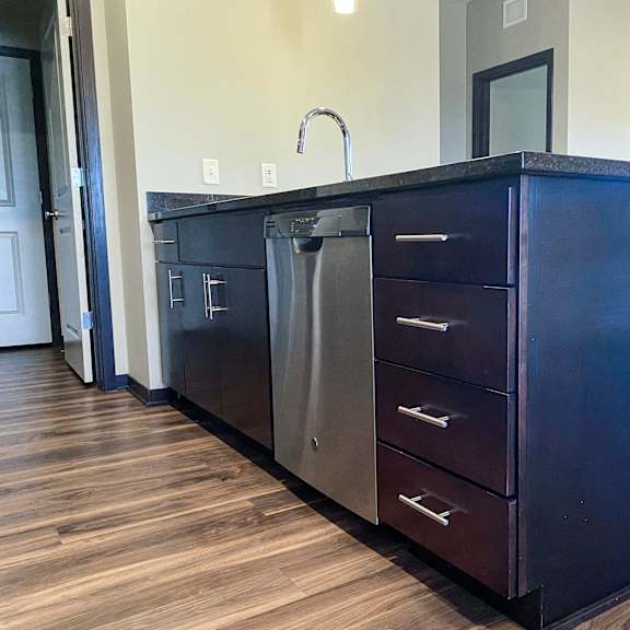 Thumbnail 19 of 23 A kitchen island with a dishwasher underneath it.