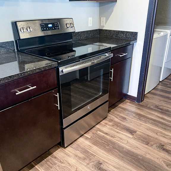Thumbnail 20 of 23 A black stove top oven with a glass door is on a counter.