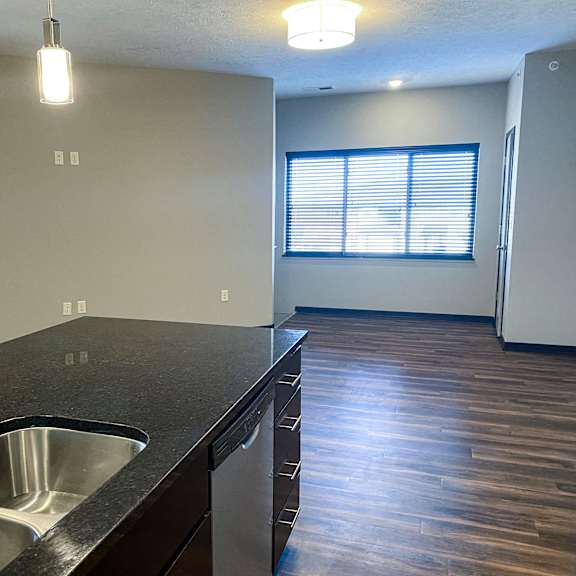 Thumbnail 22 of 23 A kitchen with a sink and a window.
