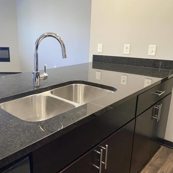 Thumbnail 12 of 16 large granite counter with double sided sink in the kitchen of the acadia floorplan