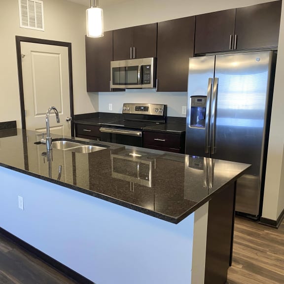 Thumbnail 11 of 16 Kitchen in the espresso finish with dark granite counter tops