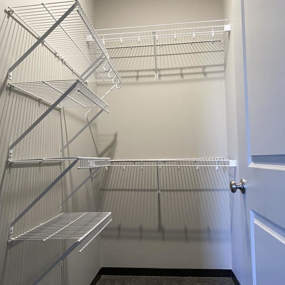 Thumbnail 8 of 16 Spacious walk in closet with an abundant amount of shelving and hanging space