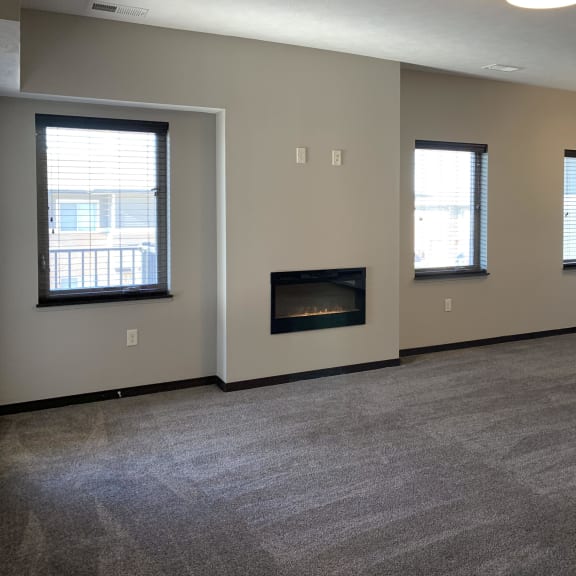 Thumbnail 12 of 26 Living room area with electric fireplace on the center wall