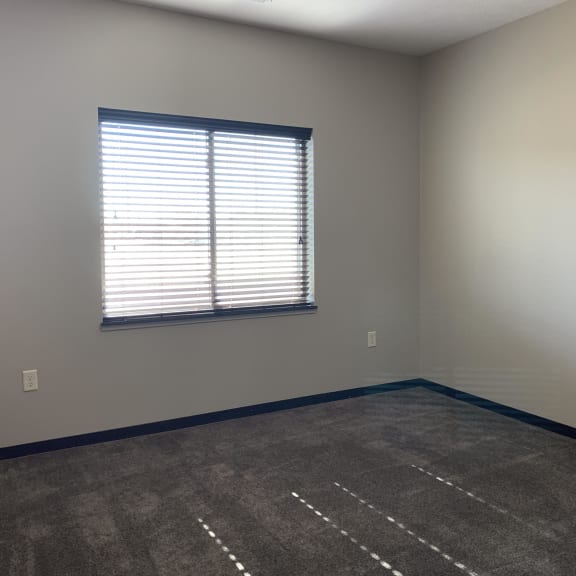Thumbnail 15 of 26 master bedroom with a window and shades open