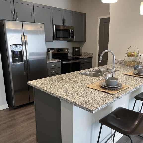 Thumbnail 5 of 8 Kitchen with slate gray cabinets and matching stainless steel appliances at The Villas at Mahoney Park