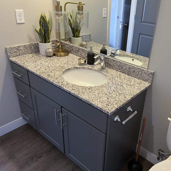 Thumbnail 8 of 8 Bathroom with slate gray cabinets and light granite countertops