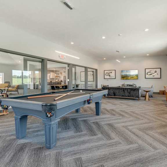 large game room including tvs, pool tables, and shuffle board at the villas at mahoney park