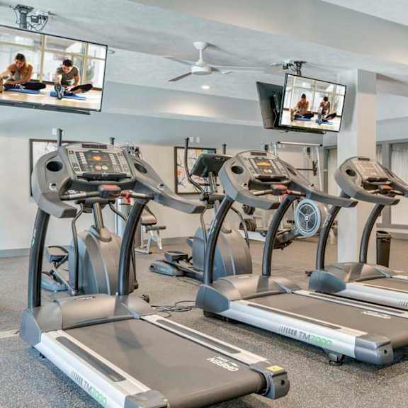 fitness center including tvs at the villas at mahoney park