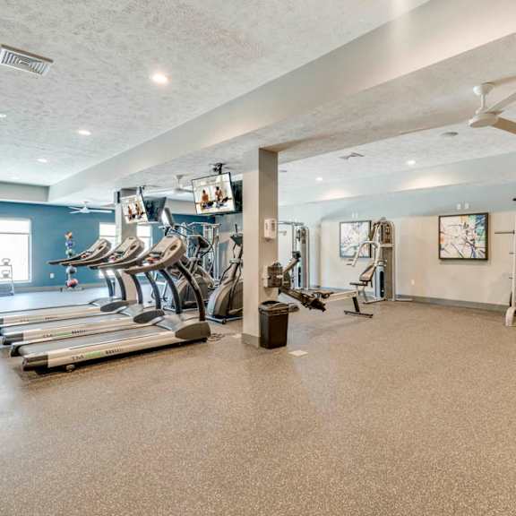 large fitness center with a variety of equipment at the villas at mahoney park