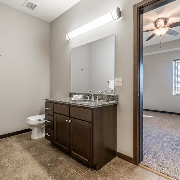 Thumbnail 11 of 11 Upscale bathroom with granite countertops and attached walk in closet at the Villas at Wilderness Ridge in Lincoln Nebraska