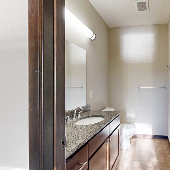 Thumbnail 18 of 22 a bathroom with a sink and a shower and a mirror