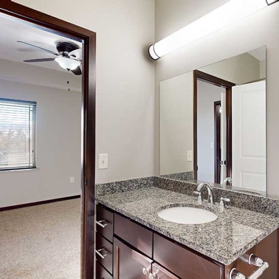 Thumbnail 19 of 22 a bathroom with a granite countertop sink and a mirror