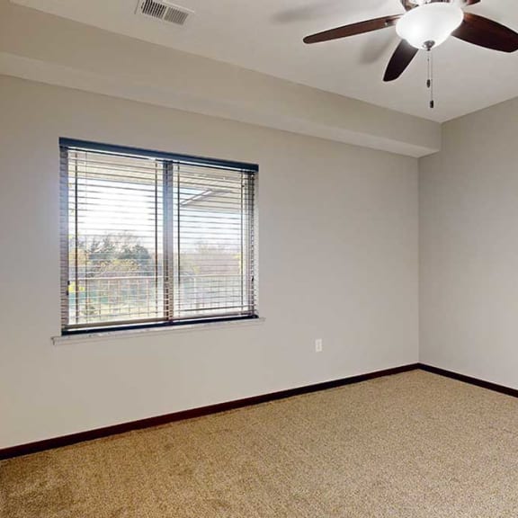 Thumbnail 16 of 22 a bedroom with a window to the balcony and a ceiling fan
