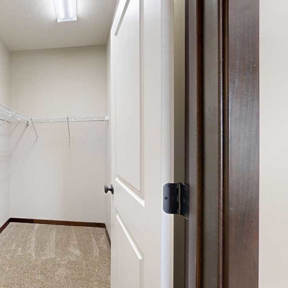 Thumbnail 21 of 22 a long walk-in closet with built-in shelving and hanging space
