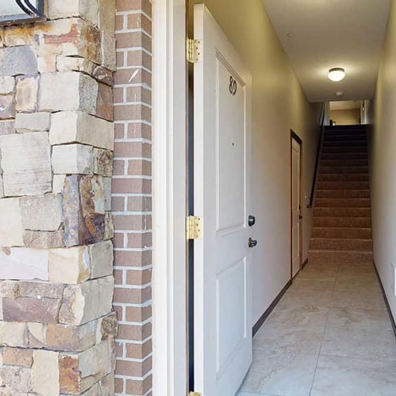 Thumbnail 2 of 22 a private front entryway that leads to an attached garage and staircase