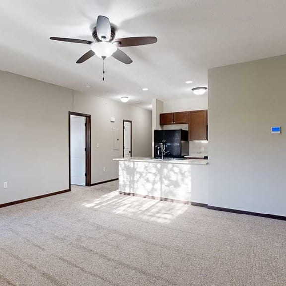 Thumbnail 14 of 22 an open-concept living room and kitchen with a ceiling fan