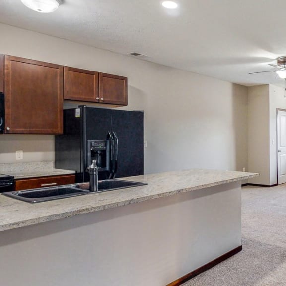 Thumbnail 4 of 19 Open floor plan with modern fireplace at The Villas at Wilderness Ridge luxury apartments in southwest Lincoln NE 68512