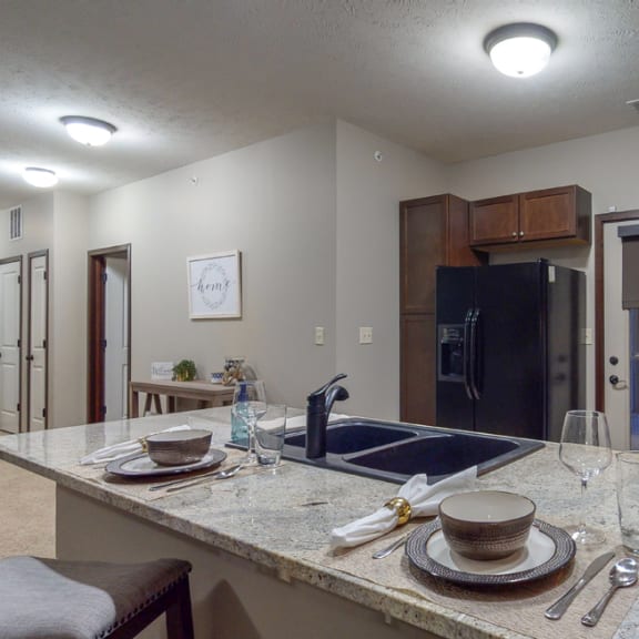 Thumbnail 5 of 19 The 2-bedroom Cedar features a spacious kitchen with peninsula counter and gorgeous countertops.