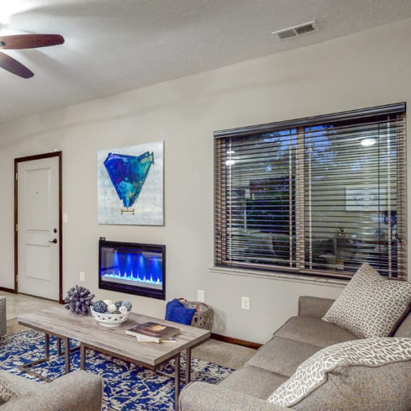 Thumbnail 8 of 19 The spacious living area of the Cedar features an electric fireplace