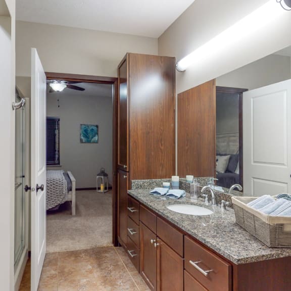 Thumbnail 11 of 19 The master bath in the Cedar floor plan features a large vanity, shower, and large linen cabinet.
