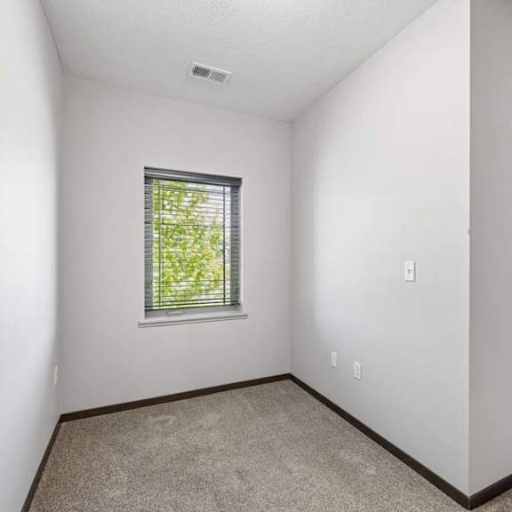 Thumbnail 27 of 40 Small carpeted nook with tall wall, window with blinds, and sliding glass door nearby.