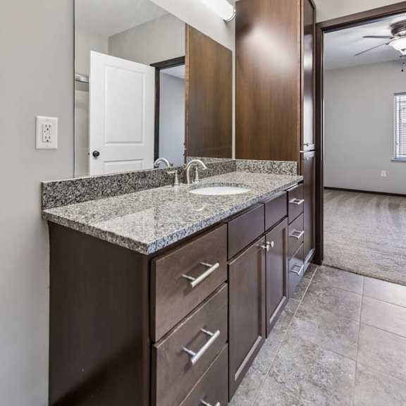 Thumbnail 33 of 59 A bathroom with a sink, mirror, and cabinets.