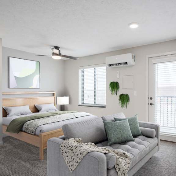 Thumbnail 9 of 25 A bedroom with a bed, a couch, and a ceiling fan.