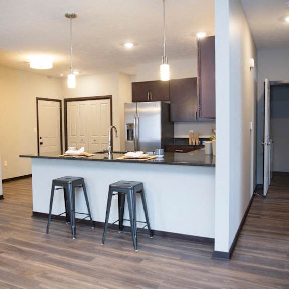 Thumbnail 12 of 17 A kitchen with a bar stool and a counter.