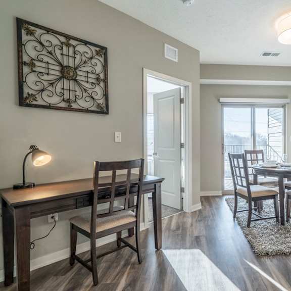 Thumbnail 5 of 23 A dining room with a table and chairs.