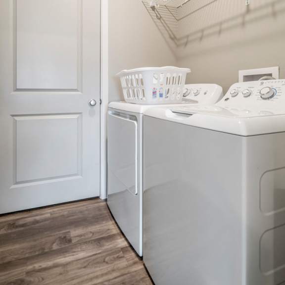 Thumbnail 13 of 23 A white door is next to a white washing machine.