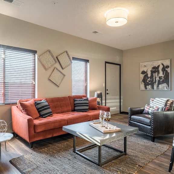 Thumbnail 11 of 16 Living room with lots of natural lighting and modern light fixtures at The Villas at Mahoney Park