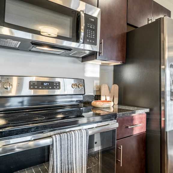 Thumbnail 10 of 16 Kitchen with stainless steel appliances and a side by side refrigerator at The Villas at Mahoney Park