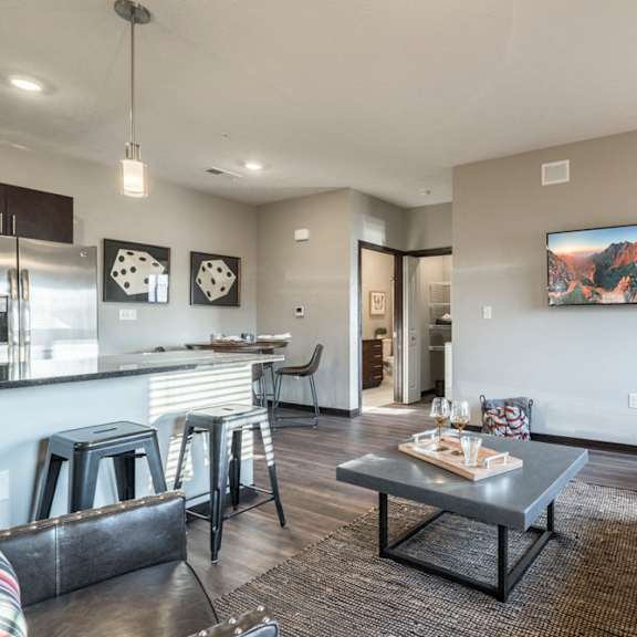 Thumbnail 12 of 16 Modern and inviting open layout of living room and kitchen at The Villas at Mahoney Park