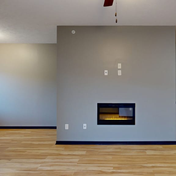 Thumbnail 7 of 17 a living room with a fireplace and hardwood floors