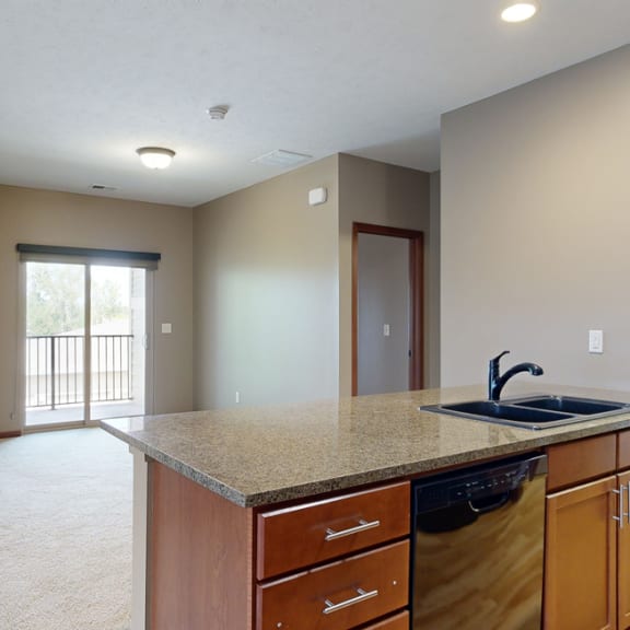 Thumbnail 7 of 20 a kitchen counter top with a stone sink in front of a dining room