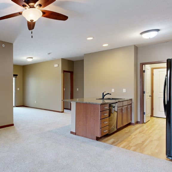 Thumbnail 6 of 20 a living room with a fireplace and a ceiling fan