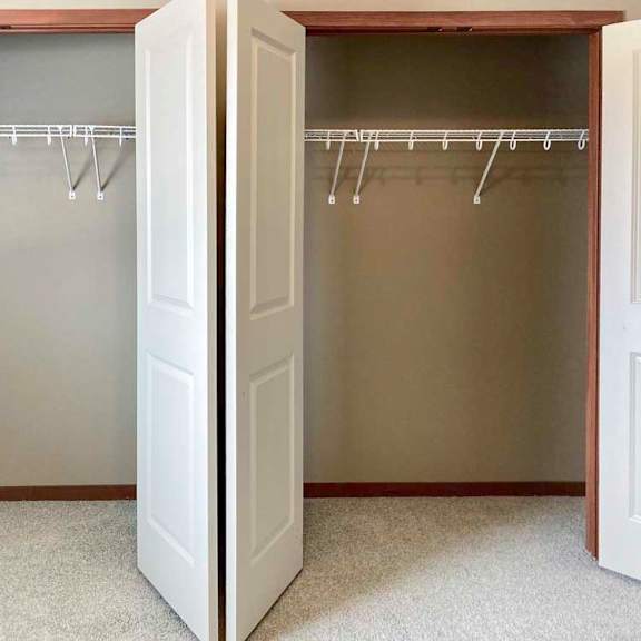 Thumbnail 15 of 19 A bedroom with two side-by-side closets.
