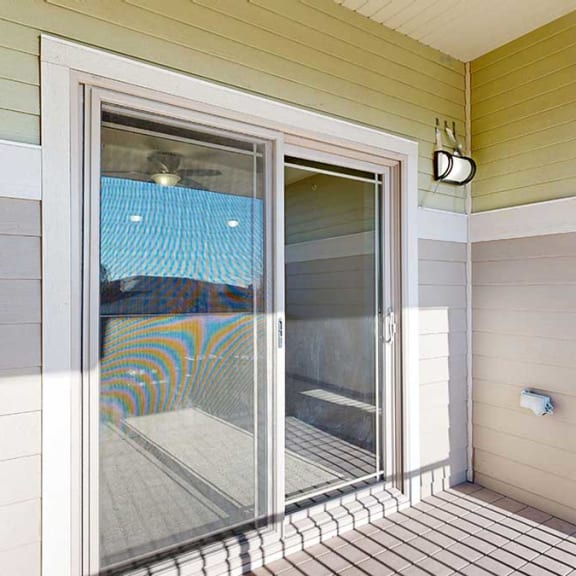 Thumbnail 13 of 22 a balcony with a sliding glass door, exterior lighting, and electrical outlets