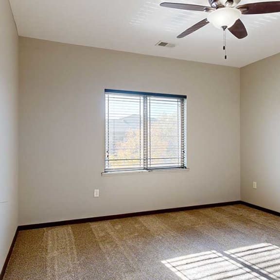 Thumbnail 18 of 22 a bedroom with a large window and a ceiling fan